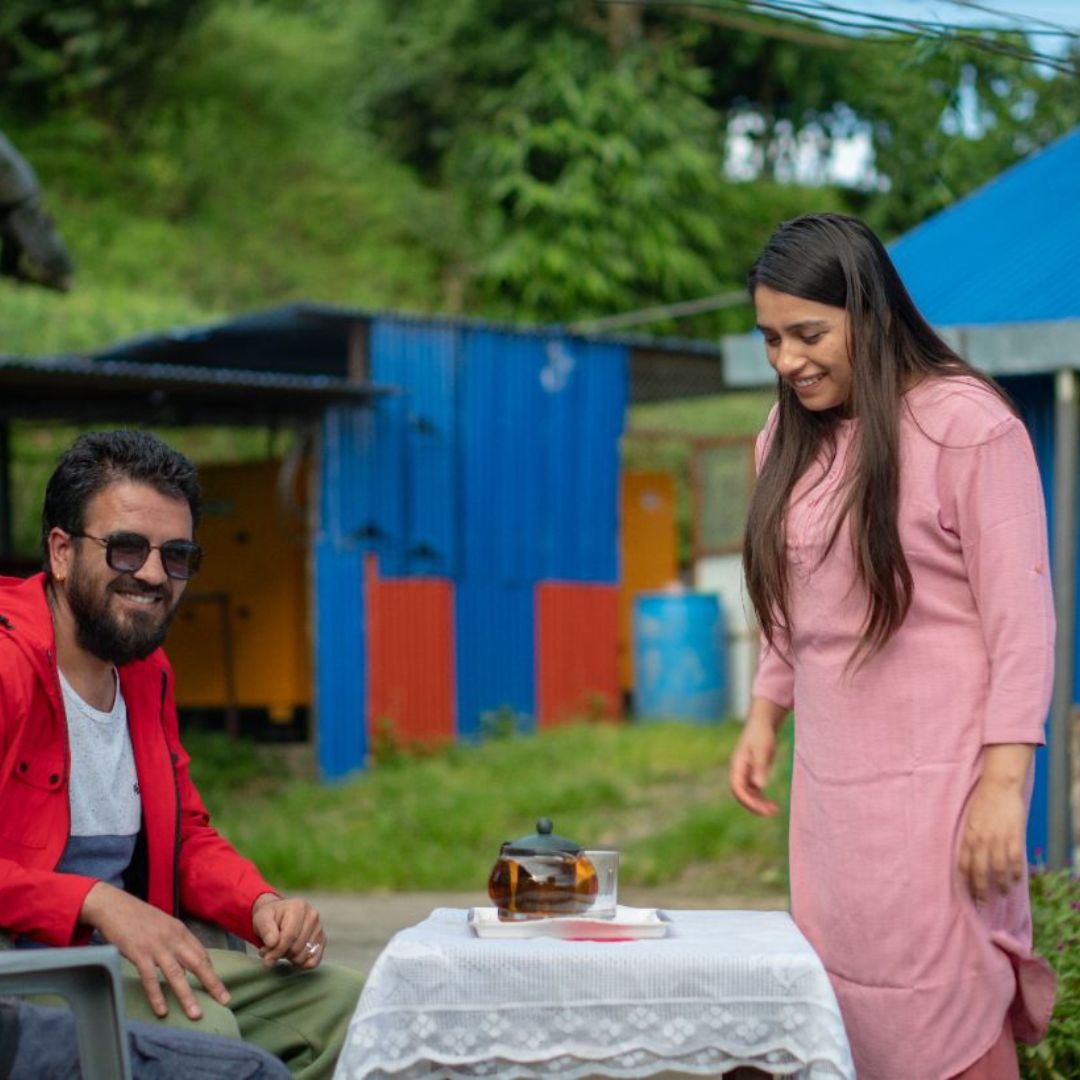 A Girl Serving Tea to Guest in Nepal