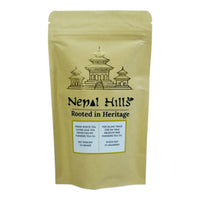 Thumbnail for A brown kraft paper resealable pouch of Nepal Hills Fresh White Tea. The packaging features a gold pagoda illustration, the brand name 'Nepal Hills,' and labels in English and French indicating a net weight of 25 grams.