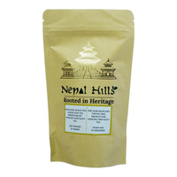 Thumbnail for A brown kraft paper resealable pouch of Nepal Hills Muscatel Black Tea. The packaging features a gold pagoda illustration, the brand name 'Nepal Hills,' and labels in English and French indicating a net weight of 25 grams.