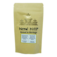 Thumbnail for A brown kraft paper resealable pouch of Nepal Hills Ruby Black Tea. The packaging features a gold pagoda illustration, the brand name 'Nepal Hills,' and labels in English and French indicating a net weight of 25 grams.