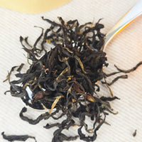 Close-up of dried black tea leaves on a white cloth